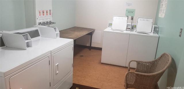 laundry room featuring washer and dryer and hardwood / wood-style floors