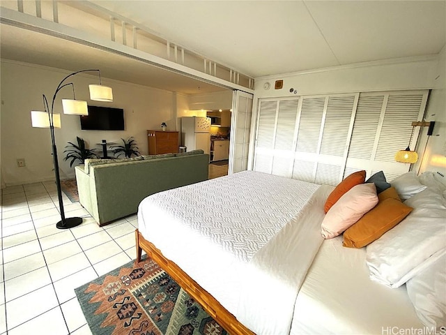 bedroom featuring ornamental molding, white fridge, and light tile patterned floors