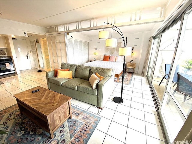 bedroom featuring light tile patterned flooring, access to outside, and crown molding