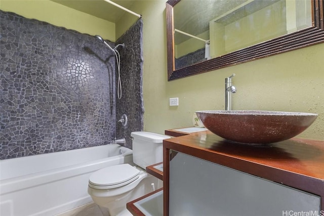 full bathroom with vanity, tiled shower / bath combo, and toilet