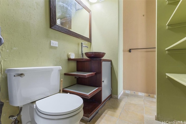 bathroom with tile patterned flooring, sink, and toilet