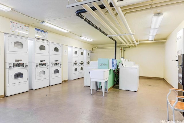 washroom featuring stacked washer / dryer, sink, and washing machine and dryer