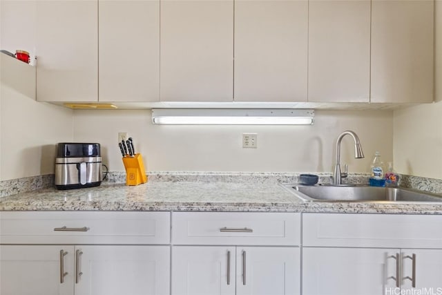 kitchen with sink and white cabinets