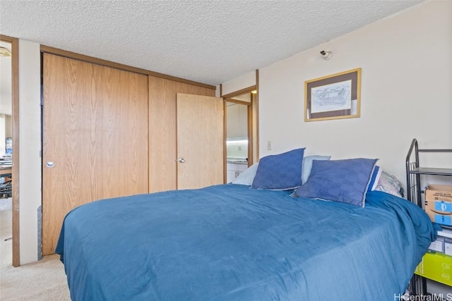 carpeted bedroom featuring a closet and a textured ceiling