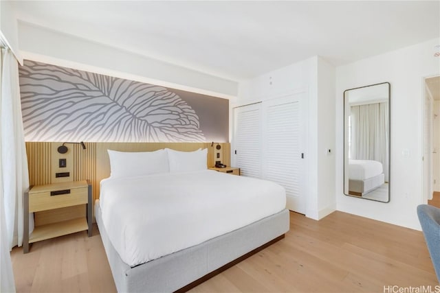 bedroom with a closet and hardwood / wood-style flooring