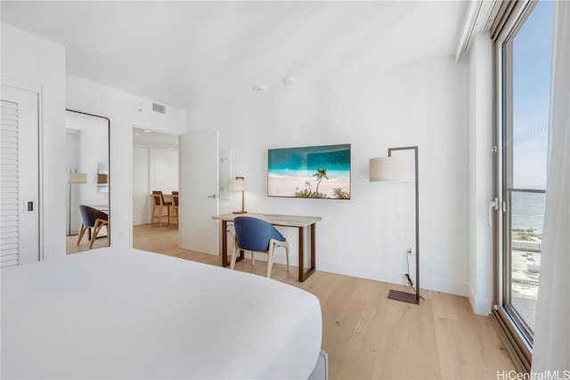 bedroom featuring multiple windows and light wood-type flooring