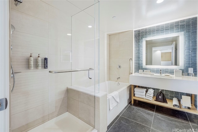 bathroom with independent shower and bath, tile walls, and tile patterned floors