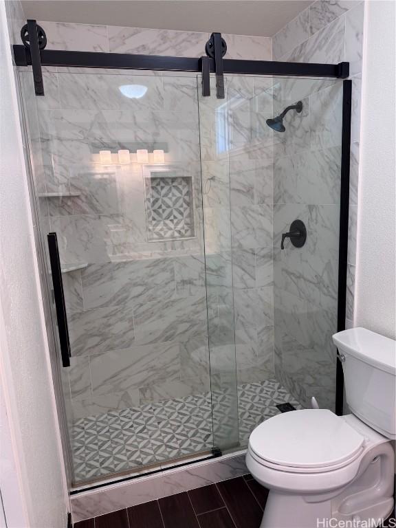 bathroom with toilet and walk in shower