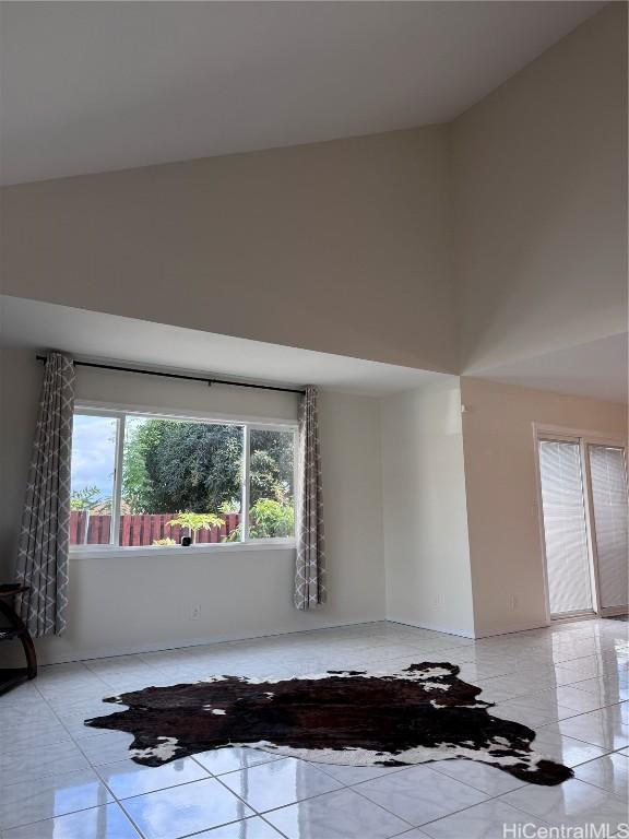 tiled empty room featuring a wealth of natural light