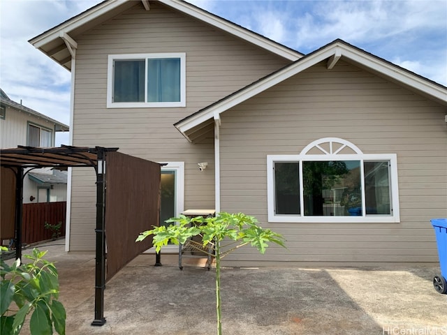 rear view of house with a pergola and a patio