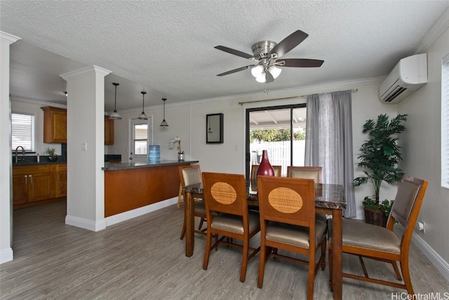 dining area featuring ornate columns, crown molding, dark hardwood / wood-style floors, and a wall unit AC