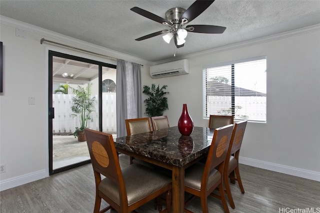 dining space with an AC wall unit, wood-type flooring, and ornamental molding