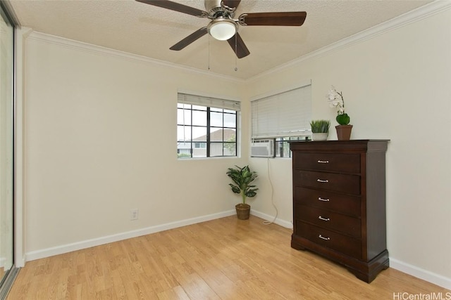 bedroom featuring a textured ceiling, cooling unit, ornamental molding, light hardwood / wood-style flooring, and ceiling fan