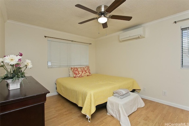 bedroom featuring an AC wall unit, light hardwood / wood-style flooring, crown molding, and ceiling fan