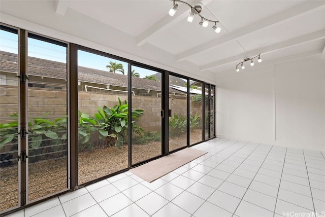 unfurnished sunroom featuring beamed ceiling