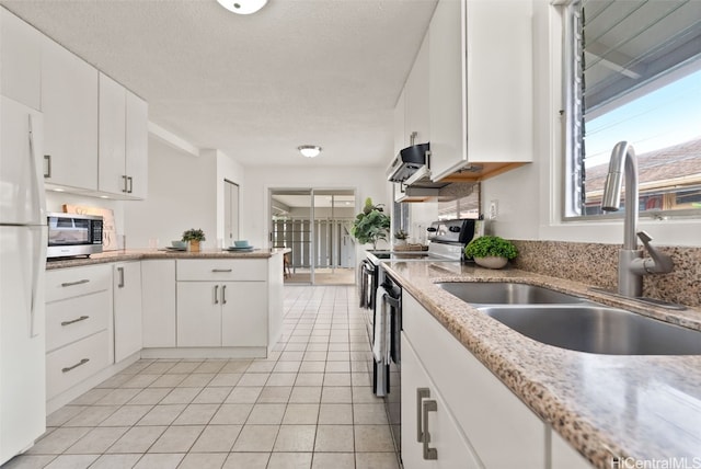 kitchen with white cabinetry, appliances with stainless steel finishes, sink, and light tile patterned floors