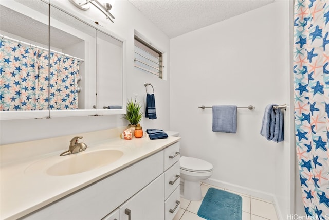 bathroom featuring vanity, toilet, tile patterned flooring, and a textured ceiling