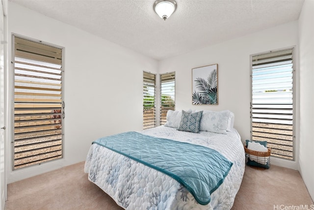 carpeted bedroom featuring a textured ceiling