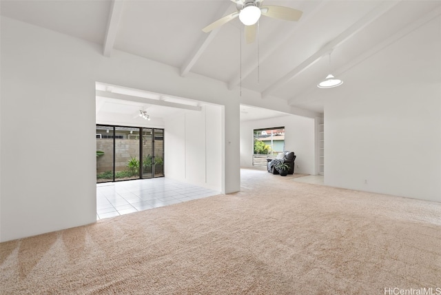 spare room with ceiling fan, light colored carpet, and vaulted ceiling with beams