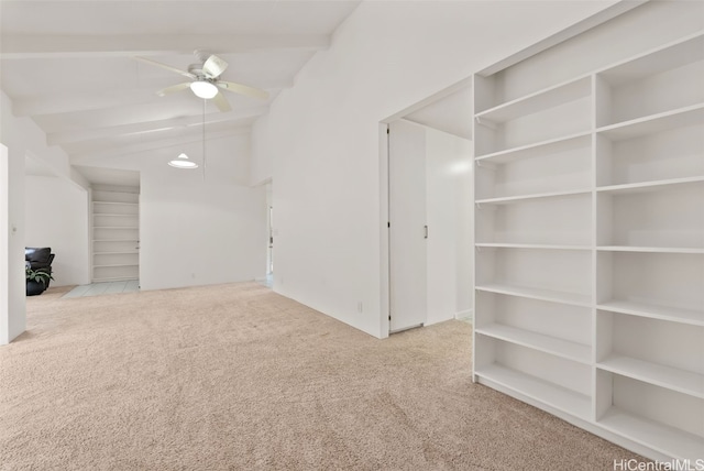 carpeted empty room featuring vaulted ceiling with beams and ceiling fan