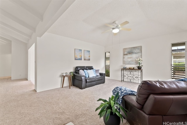 carpeted living room with vaulted ceiling with beams, a textured ceiling, and ceiling fan