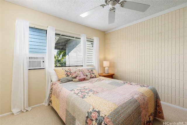 bedroom featuring light carpet, a textured ceiling, ceiling fan, and cooling unit