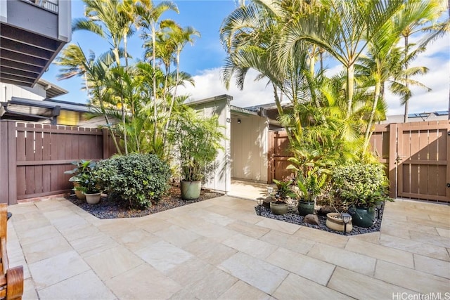 view of patio featuring fence and a gate