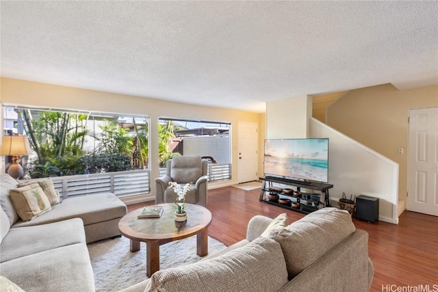 living room with hardwood / wood-style flooring and a textured ceiling