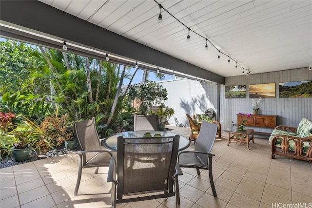 view of patio featuring outdoor dining area and fence