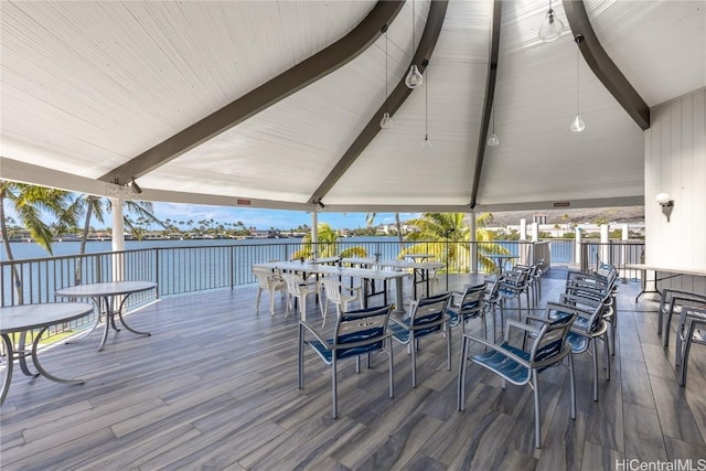 wooden deck featuring a water view and a gazebo