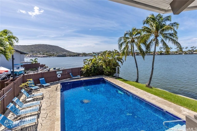 view of swimming pool with a water and mountain view and a patio area