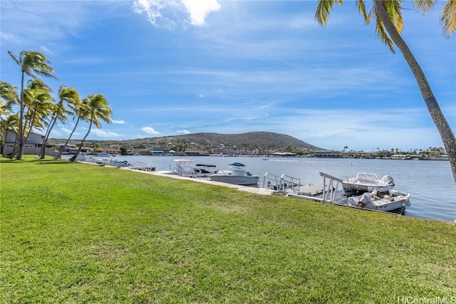 view of dock featuring a yard and a water and mountain view