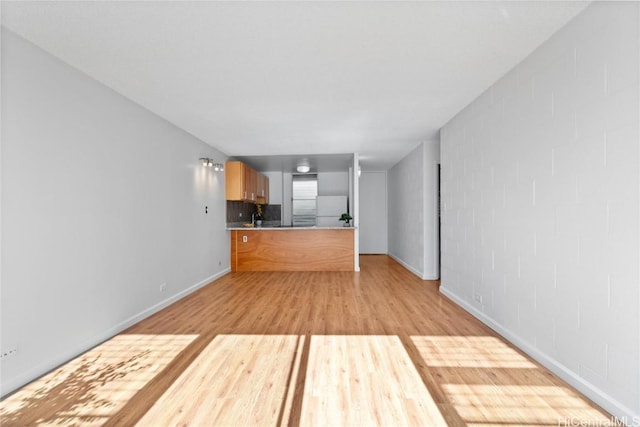 unfurnished living room featuring light hardwood / wood-style flooring