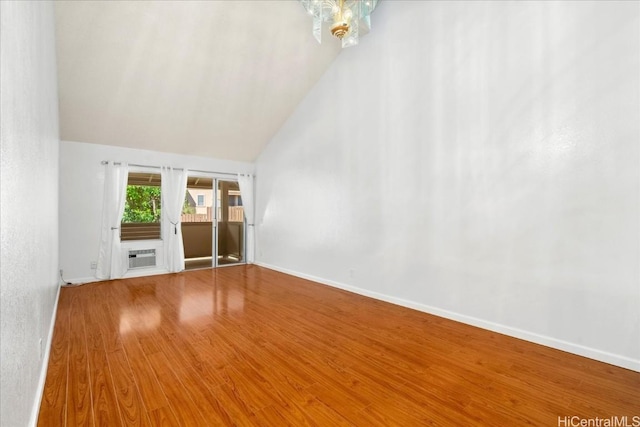 unfurnished living room with wood-type flooring and high vaulted ceiling