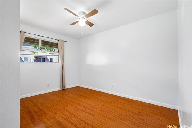 spare room with wood-type flooring and ceiling fan