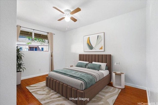 bedroom featuring hardwood / wood-style floors and ceiling fan