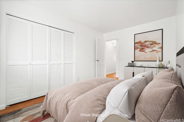 bedroom featuring wood-type flooring and a closet