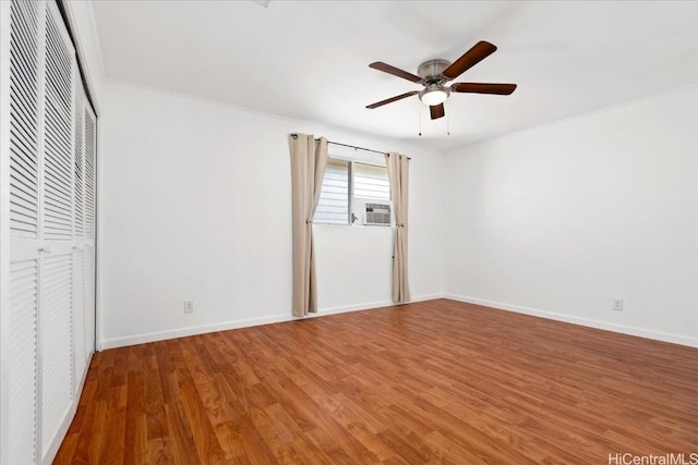 unfurnished bedroom with hardwood / wood-style flooring, cooling unit, ceiling fan, and a closet