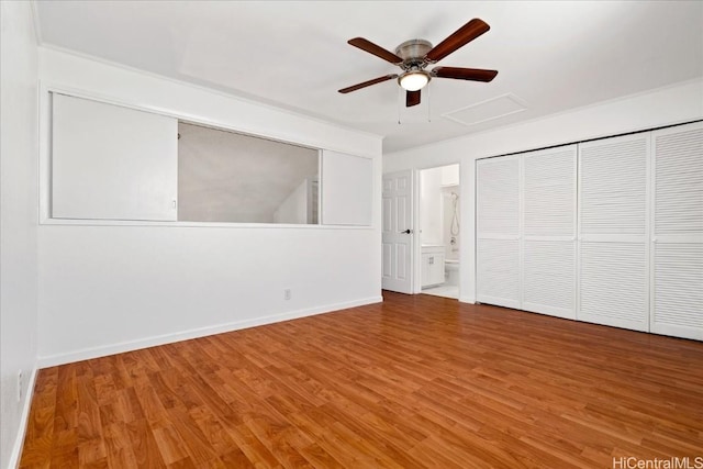 unfurnished bedroom with ceiling fan, hardwood / wood-style floors, and ensuite bath