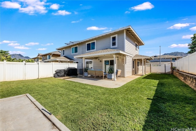 back of property featuring a lawn and a patio