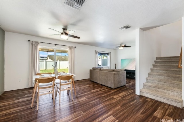 dining room with a textured ceiling, dark hardwood / wood-style floors, and ceiling fan