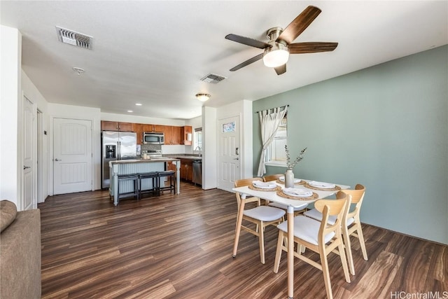 dining room with sink, ceiling fan, and dark hardwood / wood-style flooring