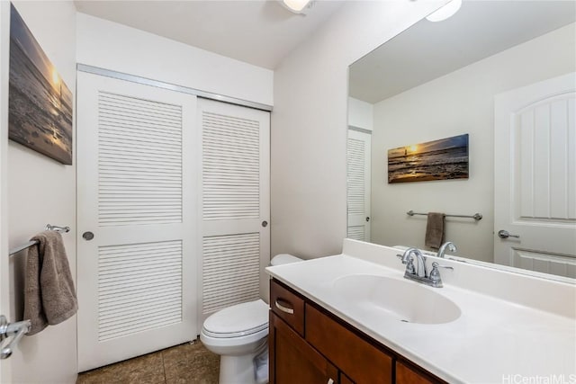 bathroom featuring toilet, tile patterned floors, and vanity