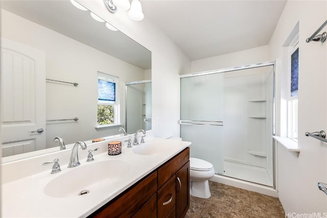 bathroom featuring toilet, walk in shower, and vanity