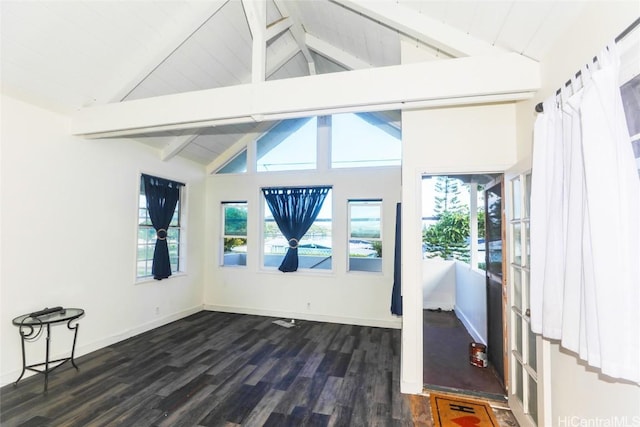 spare room with a healthy amount of sunlight and lofted ceiling with beams