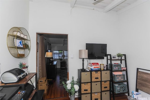 interior space featuring dark hardwood / wood-style flooring and beam ceiling