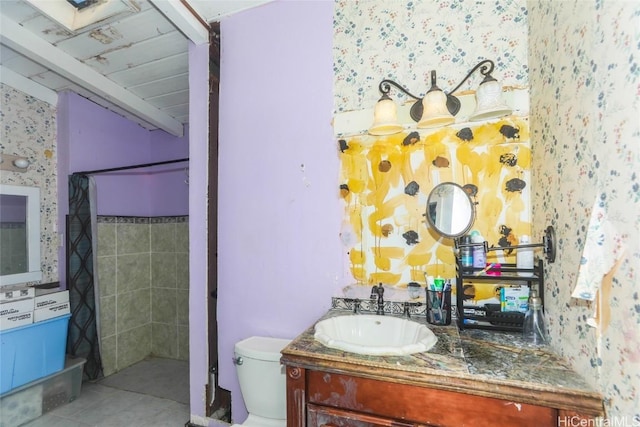 bathroom featuring vanity, a shower with shower curtain, tile patterned floors, and toilet