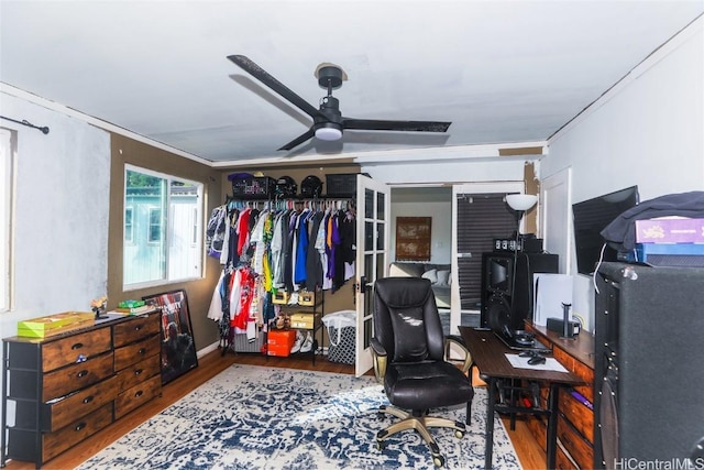 home office with crown molding, hardwood / wood-style flooring, and ceiling fan