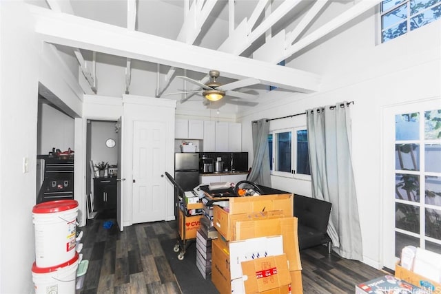 kitchen with beam ceiling, white cabinetry, dark hardwood / wood-style floors, and ceiling fan