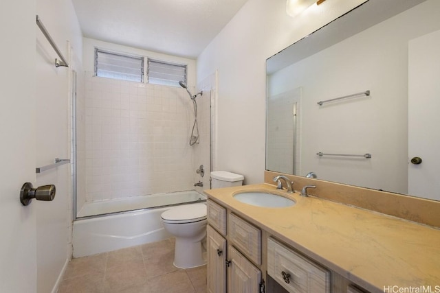 full bathroom featuring tiled shower / bath combo, vanity, tile patterned floors, and toilet